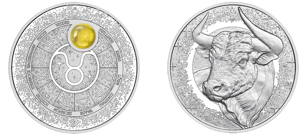 Серебряная монета 20 евро Австрия Созвездие Тельца с зодиакальным кругом, символами двенадцати созвездий, вставкой из янтаря на месте знака Тельца, стилизованное звёздное небо